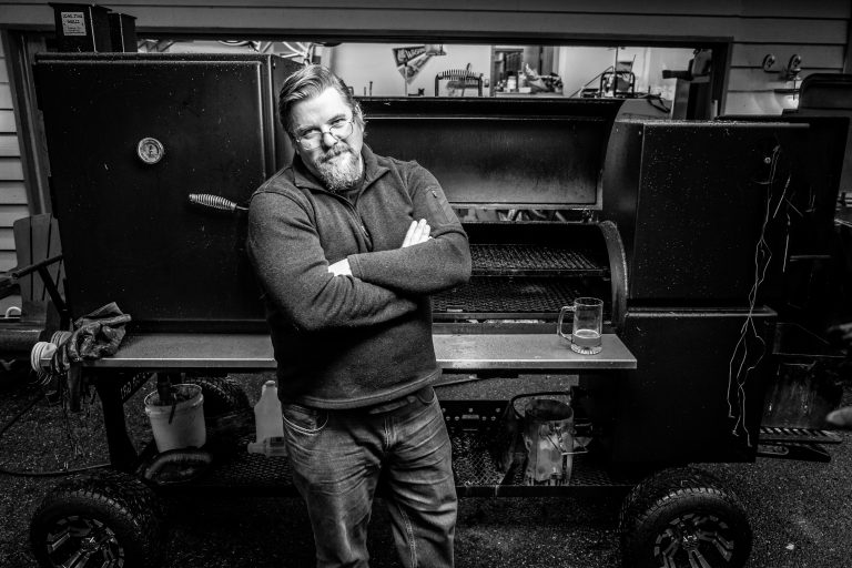 BeefStew — arms crossed, standing in front of Baby the smoker